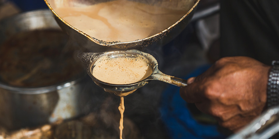 A vendor makes chai. 